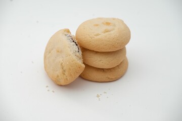 Stack of soft butter cookies with a chocolate filling, isolated on white background