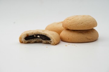 Stack of soft butter cookies with a chocolate filling, isolated on white background