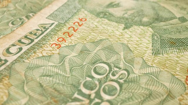 Close-up shot of a Cuban 5-peso banknote with a sliding motion.