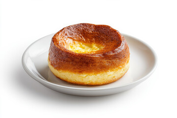 Delicious golden-brown baked pudding on a white plate, perfect for dessert lovers. isolated on white background.