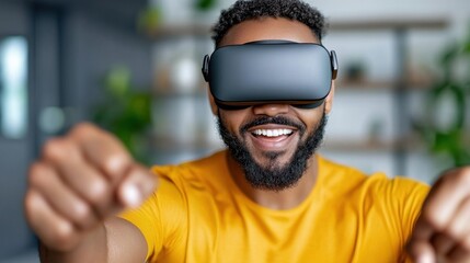 Enthusiastic and energetic man with a broad smile on his face wearing a virtual reality headset and engaging in an immersive VR boxing or dance workout experience