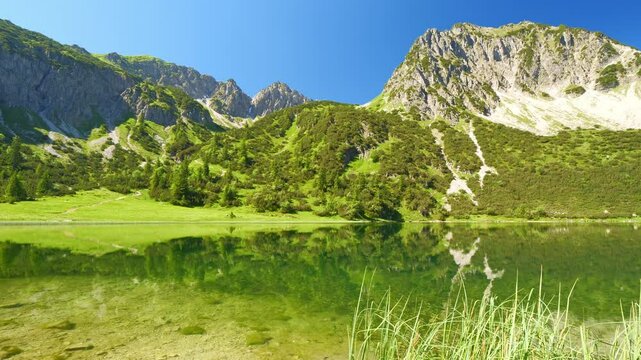 Embrace the serenity of a mountain lake with clear waters, fresh green hills, and a peaceful, refreshing atmosphere, offering a perfect escape into nature&rsquo;s beauty.