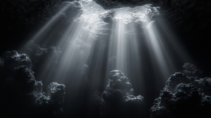 Obraz premium Sunlight streaming through cavern roof illuminating rocky landscape