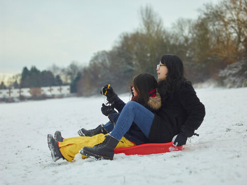 mother and daughter playing in snow