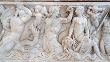 Mythological scene carved in marble wall inside historic building in Rome