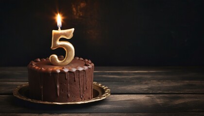 5th Anniversary candle lit on a cake with copy space