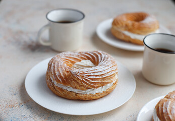 Cream puffs with whipped cream and sour cherries.