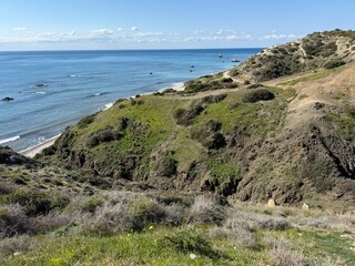 Scenic beach and rock formations in Cyprus. Mediterranean Sea, road, travel, view of mountains and sea.