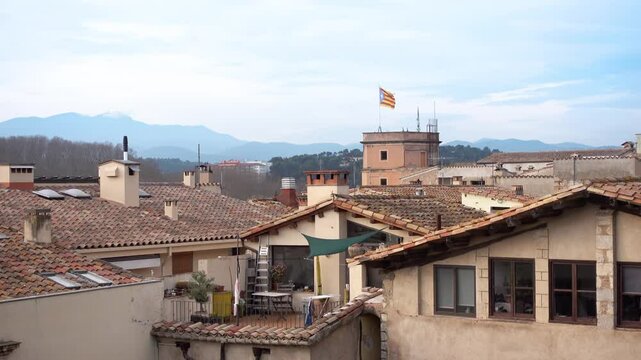 view of the roofs of the city of Girona with Catalan Estelada Blava