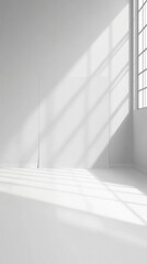 Fototapeta premium Minimalist light gray backdrop in sunlit room for design and creativity