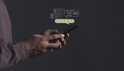 Consumer Satisfaction; Young Man hand holding Smart Phone with five star to review and give 5 stars with very good results in service, Good review 5 star rating choice feedback