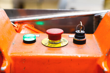 A red Emergency STOP button used for safety on industrial equipment, machine machinery electrical...