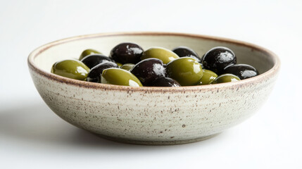 Rustic ceramic dish filled with green and black olives - mediterranean cuisine concept
