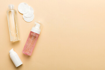 Micellar cleansing water and discs to remove cosmetics and cleanse the skin on colored background. Copy space top view