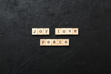 joy love peace word written on wood block. joy love peace text on cement table for your desing, concept