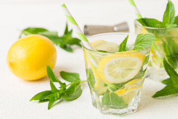 Mojito cocktail. Refreshing mojito cocktail with lime, lemon and mint in a tall glass with a stick