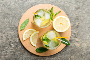 Caipirinha, Mojito cocktail, vodka or soda drink with lime, mint and straw on table background. Refreshing beverage with mint and lime in glass top view flat lay