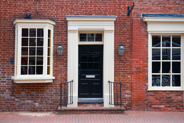 entrance of a brick building. Door and windows in old red brick house.
