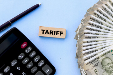 USA tariff tax concept with calculator, pen, and indian currency on blue background