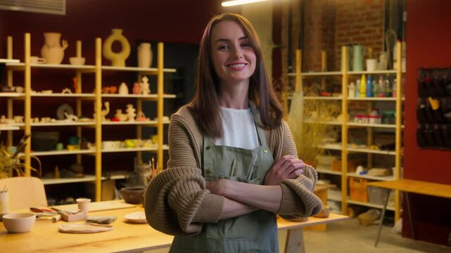 Portrait smiling woman art designer craftswoman potter sculptor handmade creative artist Caucasian girl posing crossed hands female small business owner saleswoman pottery ceramics shop craft gallery