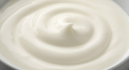 Close-up of white natural creamy vanilla yogurt. Top view. White texture of whipped cream, buttercream, and cosmetic cream. Close-up of vanilla yogurt.