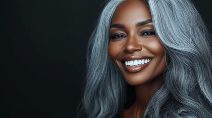 Fototapeta premium An african american woman with long gray hair. A woman with dark skin and beautiful face. A young woman smiling with long hair and gray aging. A woman of african american descent with lifestyle long.