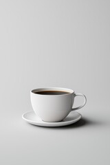 A minimalist white coffee cup filled with dark brew, resting on a matching saucer against a soft gray backdrop.