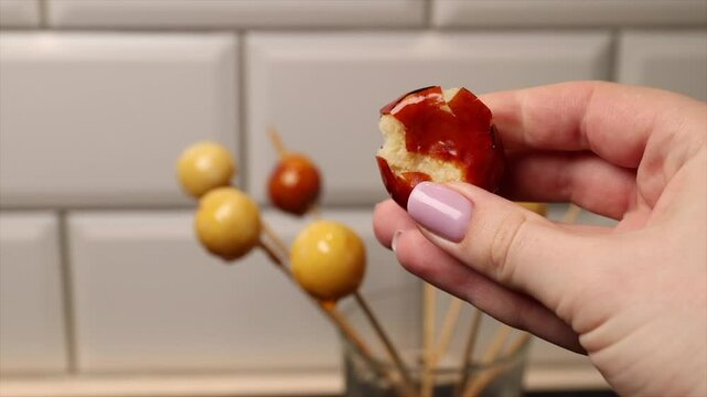 Breaking coconut balls of Brazilian dessert bala baiana. Traditional caramelized coconut treat.