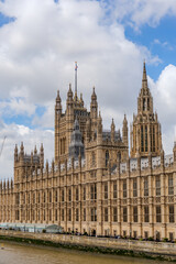 Fototapeta premium the iconic Palace of Westminster, home to the UK Parliament, with its intricate Gothic architecture along the River Thames.