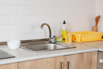 kitchen interior with white sink and wooden utensil in modern kitchen