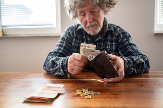 Senior man counting his pension money
