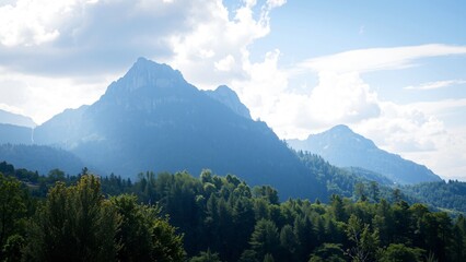 Fototapeta premium Majestic Mountain Range with Lush Green Forest Under a Cloudy Sky