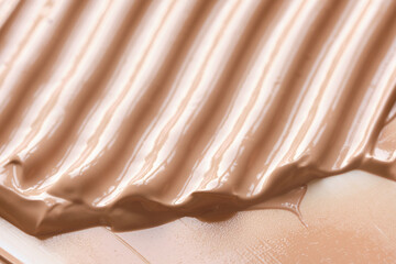 Liquid make up foundation or concealer cosmetic texture close up. Beauty abstract