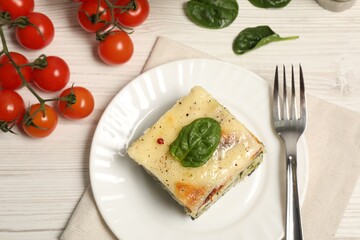 Delicious spinach lasagne served on white wooden table, flat lay