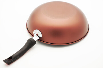 Close-up of the edge of an iron frying pan used in home kitchens