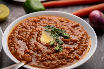 Pav bhaji is a fast food dish from India consisting of a thick vegetable curry served with a soft bread roll