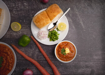 Mumbai Style Pav or paav bhaji is a fast food dish from India, consists of a thick vegetable curry served with a soft bread roll, served in a plate