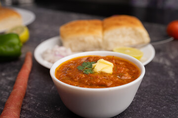 Mumbai Style Pav or paav bhaji is a fast food dish from India, consists of a thick vegetable curry served with a soft bread roll, served in a plate