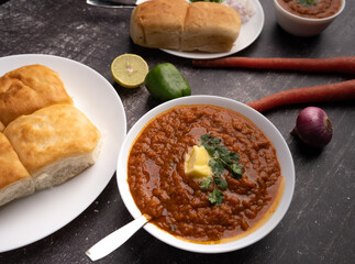 Mumbai Style Pav or paav bhaji is a fast food dish from India, consists of a thick vegetable curry served with a soft bread roll, served in a plate