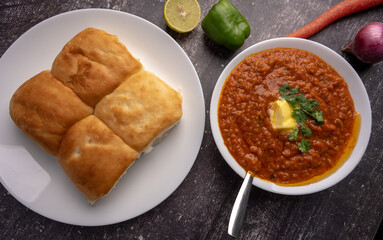Mumbai Style Pav or paav bhaji is a fast food dish from India, consists of a thick vegetable curry served with a soft bread roll, served in a plate