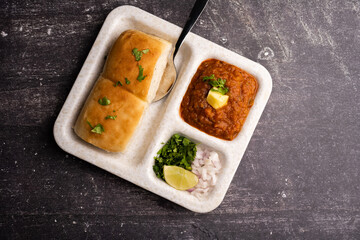 Mumbai Style Pav or paav bhaji is a fast food dish from India, consists of a thick vegetable curry served with a soft bread roll, served in a plate
