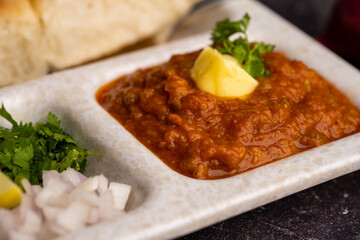Pav bhaji is a fast food dish from India consisting of a thick vegetable curry served with a soft bread roll