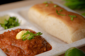 Pav bhaji is a fast food dish from India consisting of a thick vegetable curry served with a soft bread roll