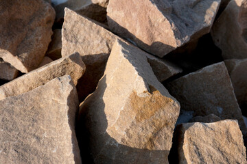 Natural stones piled together under warm sunlight in a serene setting