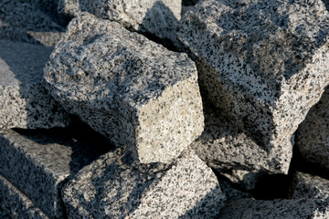 Granite stones stacked in a construction yard during daylight hours