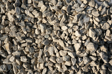 Textured stones scattered across a sunlit construction site