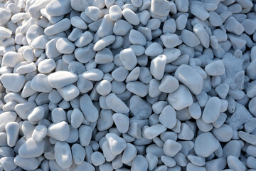 Natural white pebbles create a serene landscape in bright sunlight