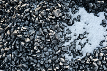 Textured stones and frost create a serene winter landscape