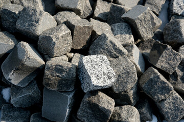 Natural granite stones scattered on a construction site in daylight