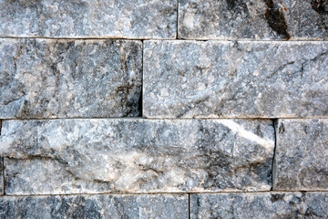 Intricate patterns of gray stone in a textured wall composition